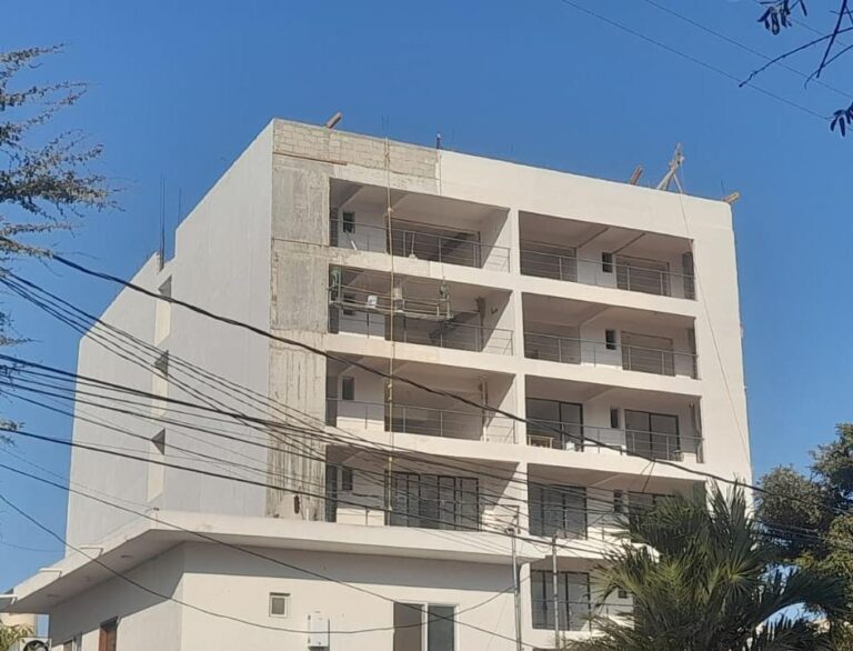 Work continues with the application of stucco on the rear facade