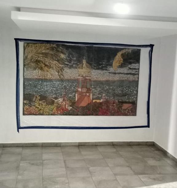 Ceiling panels with mosaic are being completed in the lobby area.