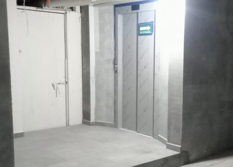 Completion of finishing wall preparation for elevator door at basement level.