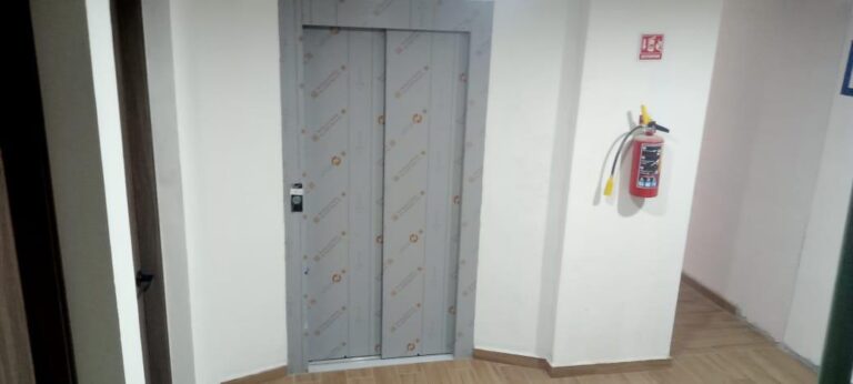 Completion of patching and painting in the fourth level apartment walkway